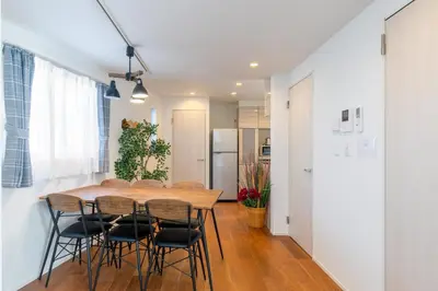 a kitchen and dining room with a wooden table and chairs at SHIBUYA TOKYO in Tokyo