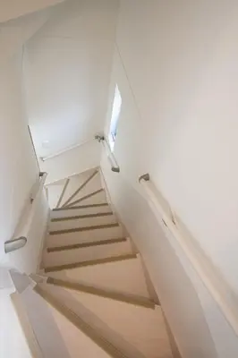 a staircase in a house with white walls and wooden floors at SHIBUYA TOKYO in Tokyo