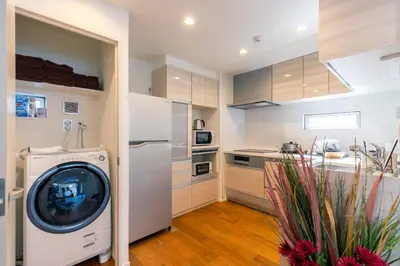 a kitchen with a washing machine in a room at SHIBUYA TOKYO in Tokyo