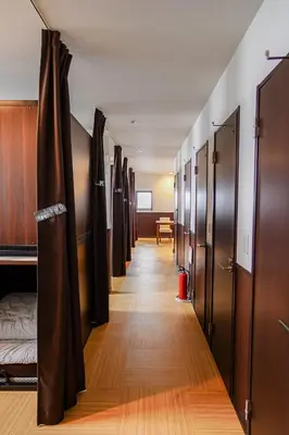 a row of lockers are lined up in a hallway at SAMURAI STAY \u6d17\u8db3\u6c60-male only \u7537\u6027\u5c02\u7528 in Tokyo