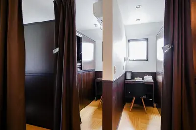 a room with a desk and a table with a window at SAMURAI STAY \u6d17\u8db3\u6c60-male only \u7537\u6027\u5c02\u7528 in Tokyo