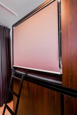 a projection screen on a stand in a room at SAMURAI STAY \u6d17\u8db3\u6c60-male only \u7537\u6027\u5c02\u7528 in Tokyo
