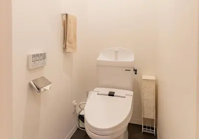 a bathroom with a white toilet in a room at COCOSHUKU Nakano in Tokyo