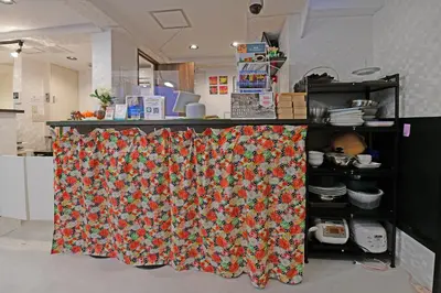 a kitchen with a table with a curtain on it at \u7121\u6599wi-fi JING HOUSE \u79cb\u8449\u539f \u96fb\u52d5\u81ea\u8ee2\u8eca\u30ec\u30f3\u30bf\u30eb in Tokyo
