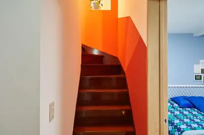a colorful staircase in a room with a bed at Designer's Villa in Shinjuku-ku Shin-Okubo sta 6 min walk F in Tokyo