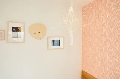 a hallway with a wall with pictures and a chandelier at Designer's Villa in Shinjuku-ku Shin-Okubo sta 6 min walk F in Tokyo