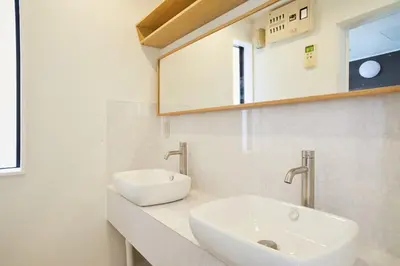 a white bathroom with a sink and a mirror at Designer's Villa in Shinjuku-ku Shin-Okubo sta 6 min walk F in Tokyo