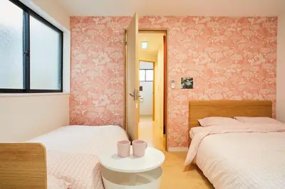 a bedroom with two beds and a table with cups on it at Designer's Villa in Shinjuku-ku Shin-Okubo sta 6 min walk F in Tokyo