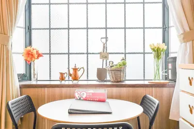a table and chairs in a kitchen with a window at JINGHOUSE小岩 Direct to Shinjuku/airport/close to station in Tokyo