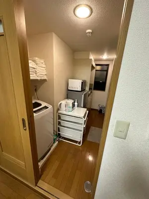 a small kitchen with a stove and a microwave at honeys guest house elevator , wash machine, huge closet space, private bathroom, walk to skytree in 10 minutes in Tokyo