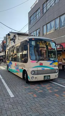 a bus is parked on the side of a street at Homestay Intimo Amigo in Tokyo