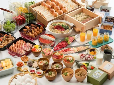 a table topped with lots of different types of food at Vessel Inn Takadanobaba Station in Tokyo