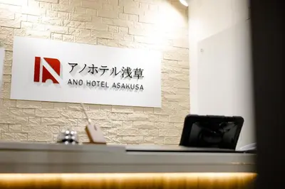 a sign on a wall with a desk and a laptop at Ano Hotel Asakusa in Tokyo