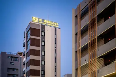 a tall building with a sign on top of it at \u82e5\u6d45\u8349\u548c\u5fc3\u30db\u30c6\u30eb in Tokyo