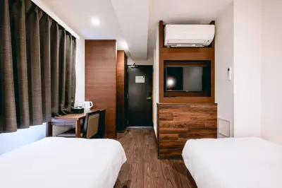 a hotel room with two beds and a television at \u82e5\u6d45\u8349\u548c\u5fc3\u30db\u30c6\u30eb in Tokyo