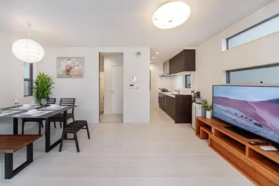 a living room and dining room with a large flat screen tv at \u6c60\u888b\u5546\u5708jr\u5c71\u624b\u7dda \u5927\u585a\u99c5\u3088\u308a\u65b0\u7b51\u5225\u8358 in Tokyo
