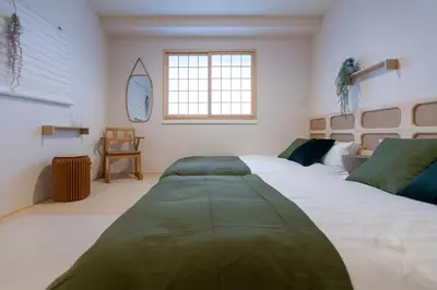 a bedroom with two beds and a window at Asakusa YOSHII Designer Hotel in Tokyo