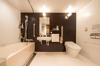 a bathroom with a white toilet and a sink at karaksa hotel colors Tokyo Yaesu in Tokyo