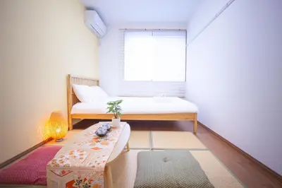 a small room with a bed and a table at Ustay Kitakoiwa in Tokyo