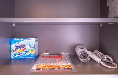 a shelf with a box of cereal and a toothbrush at Ustay Kitakoiwa in Tokyo