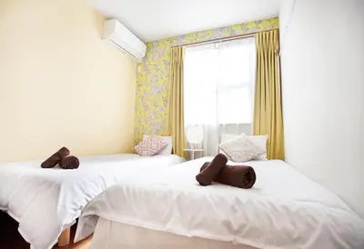 a room with two beds with brown teddy bears on them at Ustay Kitakoiwa in Tokyo