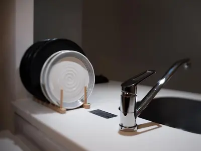 a fan sitting on a bathroom counter next to a sink at Ustay ueno in Tokyo