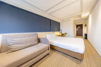 a hotel room with a bed and a couch at L stay & grow Harumi in Tokyo