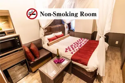 a room with aoir smoking room with a bed and a couch at BaliAn Resort Forest Ikebukuro in Tokyo
