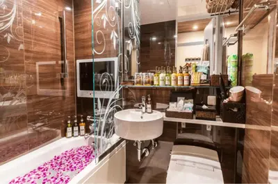 a bathroom with a sink and a bath tub at BaliAn Resort Forest Ikebukuro in Tokyo