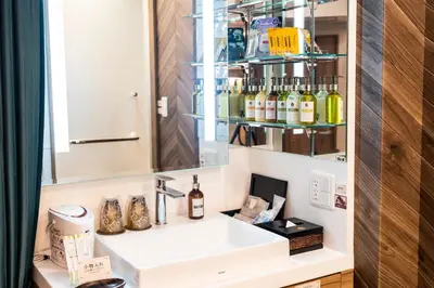 a bathroom with a sink and a mirror at Hotel Bali An Resort Shinjuku Forest in Tokyo