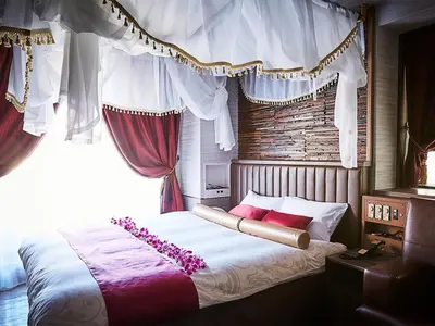 a bedroom with a large bed with a window at Petit Bali Ikebukuro in Tokyo