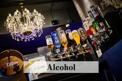 a bar with a bunch of bottles of alcohol at Petit Bali Ikebukuro in Tokyo
