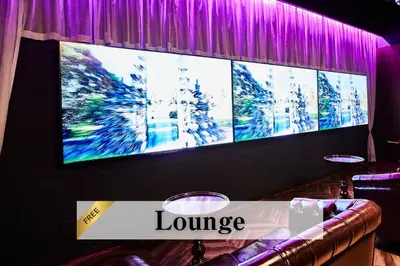 a large screen with the words lounge on a table at Petit Bali Ikebukuro in Tokyo