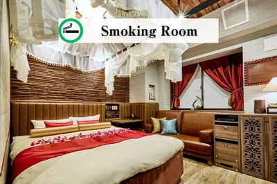 a bedroom with a bed and a smoking room at Petit Bali Ikebukuro in Tokyo