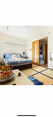 a bedroom with a bed and a table with a plate of food at \u90fd\u5fc3\u306e\u5bb630 square meter king size bed, step meter, 3-person room201 in Tokyo