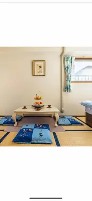 a living room with a table on a rug at \u90fd\u5fc3\u306e\u5bb630 square meter king size bed, step meter, 3-person room201 in Tokyo