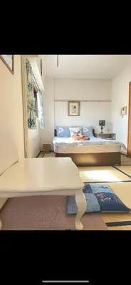 a room with two beds and a table in it at \u90fd\u5fc3\u306e\u5bb630 square meter king size bed, step meter, 3-person room201 in Tokyo