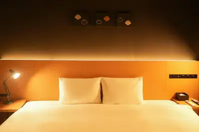 a bed with white pillows in a hotel room at N Plus Hotel Akihabara in Tokyo