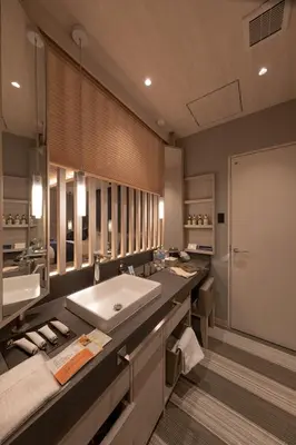 a bathroom with a large sink and a large mirror at HOTEL\u307f\u306a\u3068-MINATO- in Tokyo