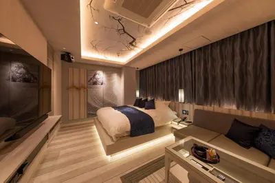 a bedroom with a bed and a couch and a tv at HOTEL\u307f\u306a\u3068-MINATO- in Tokyo