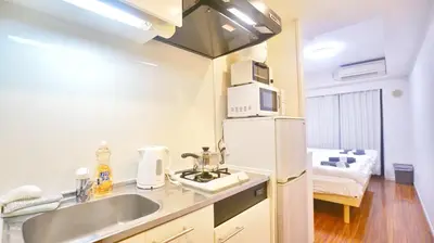 a kitchen with a sink and a refrigerator at TOKYO ICHIBAN SHINJUKU in Tokyo