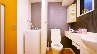 a bathroom with a white toilet and a sink at TOKYO ICHIBAN SHINJUKU in Tokyo