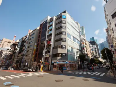 a tall building on a street in a city at Rembrandt Cabin & Spa Shimbashi - Caters to Men in Tokyo