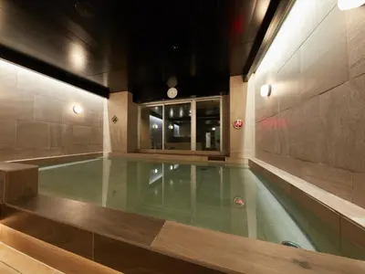 a swimming pool in a building with a pool at Rembrandt Cabin & Spa Shimbashi - Caters to Men in Tokyo