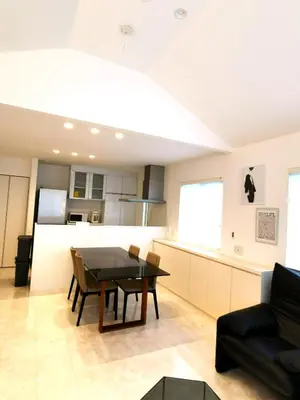 a living room with a table and a kitchen at Bell house in Tokyo