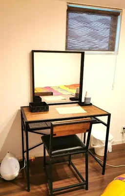 a desk with a computer monitor and a chair at Bell house in Tokyo