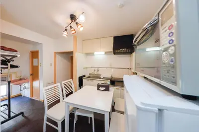 a kitchen with a white table and chairs in it at Grace Heiwajima by Tranova in Tokyo