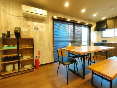 a kitchen with a table and chairs in a room at KIKI HOUSE in Tokyo