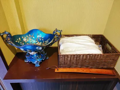 a blue vase sitting on a table next to a basket at KIKI HOUSE in Tokyo