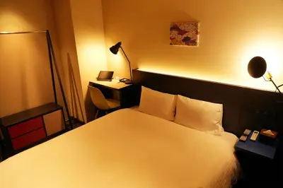 a bedroom with a white bed and a lamp at Nplus HOTEL Higashikanda-akihabara in Tokyo